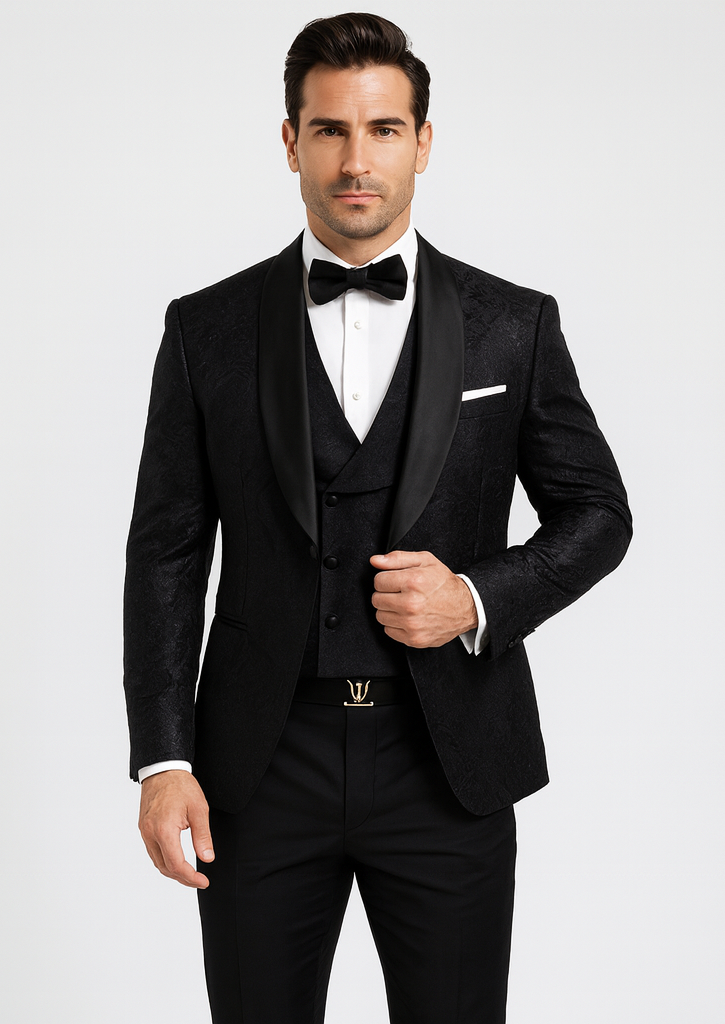 Black floral lace tuxedo for men. Single-breasted jacket with shawl lapels, matching vest, and black pants. Floral pattern adds texture for a stylish look.