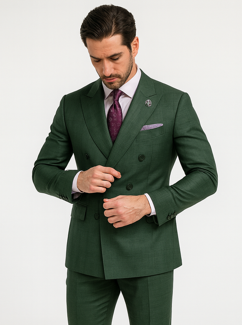 Men's luxury green double-breasted suit. Sleek, tailored fit with subtle texture. Features wide lapels and two rows of buttons. Matching trousers complete the coordinated, rich green ensemble.