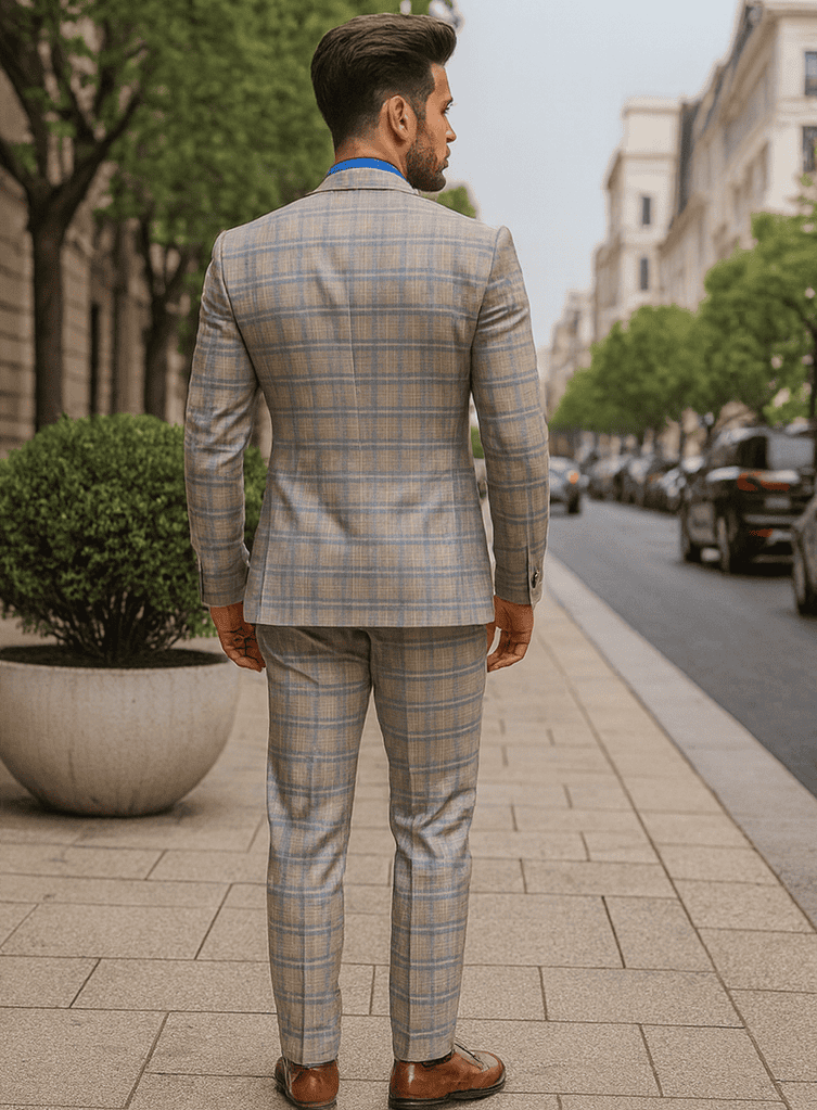 Light blue & beige plaid suit with a fitted blazer, vest, and matching trousers. Tailored with gold buttons, structured shoulders, and a narrow waist. Symmetrical pattern.