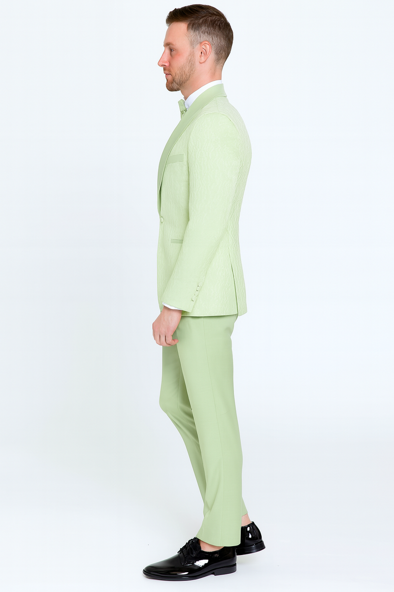 Mint green slim-fit tuxedo suit with shawl lapel, paired with a sage green bow tie. Smooth texture, structured fit, and matching trousers.