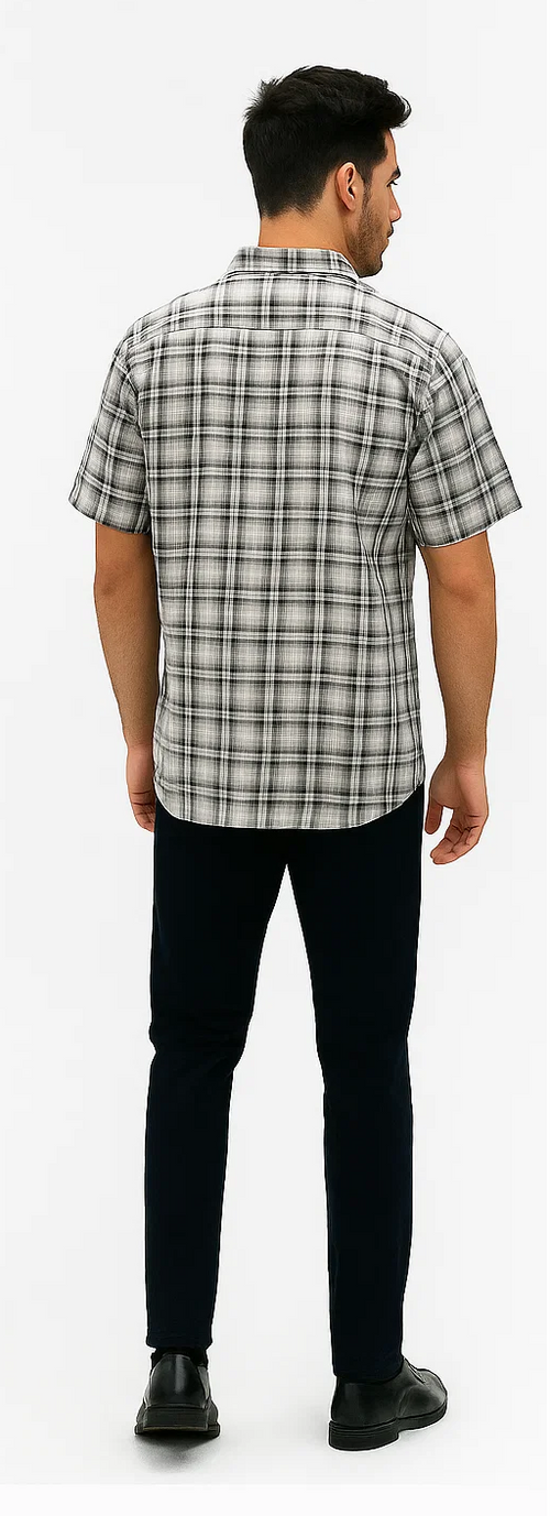 Black and white plaid walking suit for men. Short-sleeve shirt with textured checkered pattern, complemented by dark pants. Tailored fit for a structured silhouette.