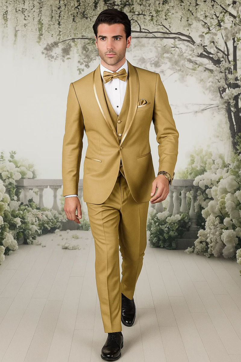 Gold champagne tuxedo. Satin shawl collar, three-piece vest. Fitted silhouette, tailored trousers. Includes matching bow tie and pocket square. Formal elegance.
