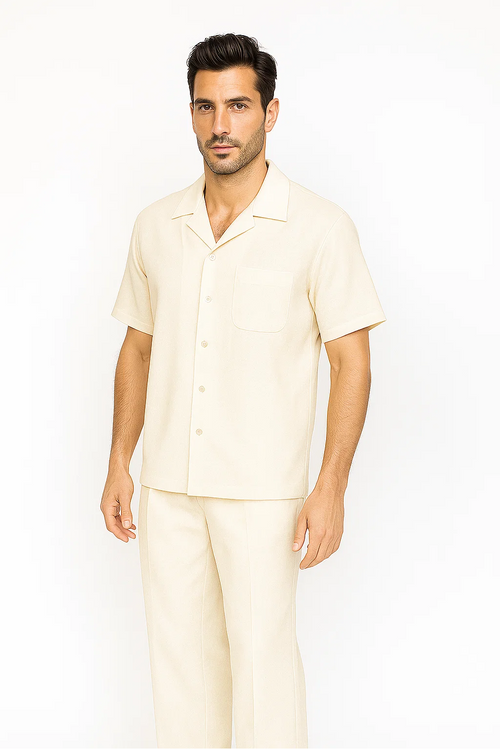 Cream-colored men's leisure suit: short-sleeved button-up shirt with chest pocket & loose pants. Soft, lightweight fabric. Perfect for relaxed wear.