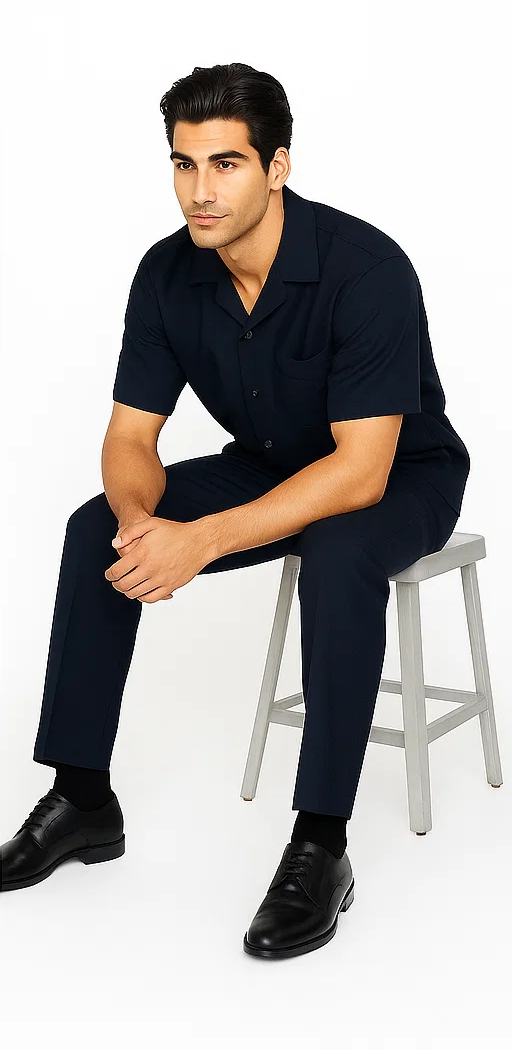 Navy leisure suit: short-sleeve collared shirt & straight-leg pants. Smooth fabric for a coordinated, relaxed look.