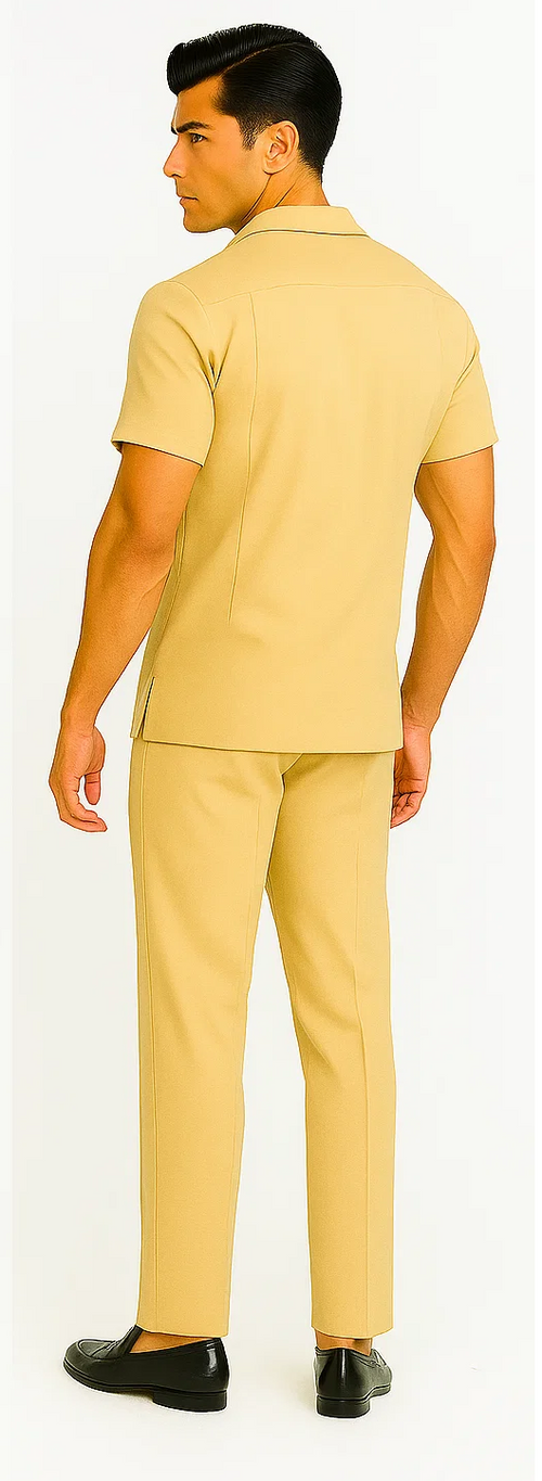 Sand-colored men's leisure suit: short-sleeved shirt (collar, straight cut) and tailored straight-leg pants. Smooth, likely lightweight material. Cohesive look. Paired with black shoes.