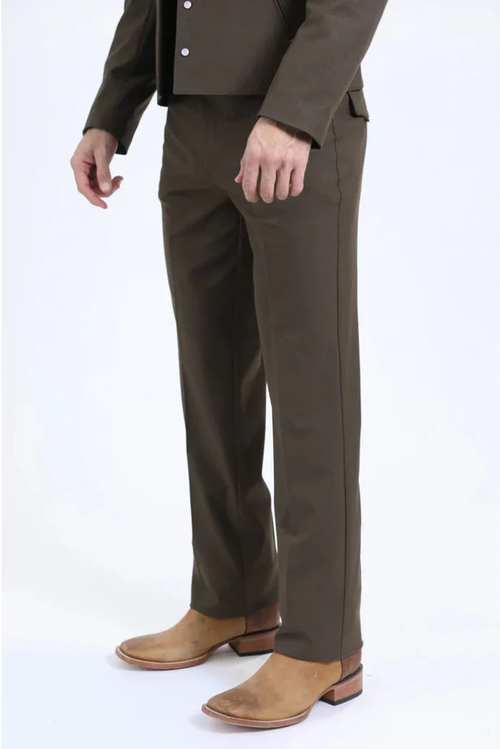Men's brown western sport suit. Fitted design with straight trousers and a tailored, short jacket. Sturdy fabric, silver buttons, and light tan shoes suggest formal wear.