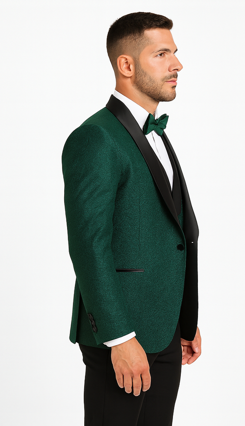 Men's hunter green designer tuxedo with textured fabric, black satin shawl lapel, and single-button closure. Includes white dress shirt and black bow tie.