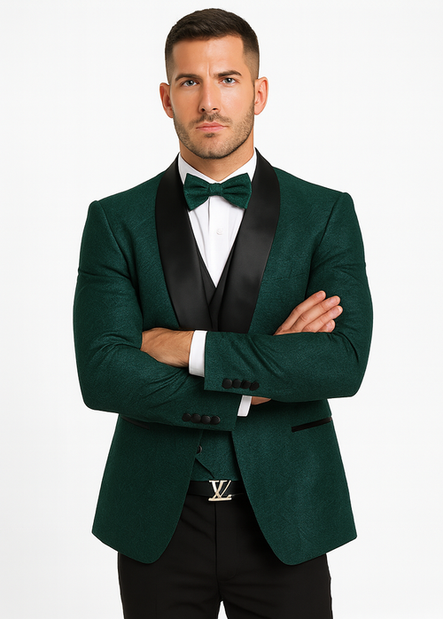 Hunter green designer tuxedo: single-breasted jacket, black satin shawl lapel, matching vest, white shirt, bow tie. Textured floral fabric, tailored fit with buttoned cuffs. Black pants complete the formal look.