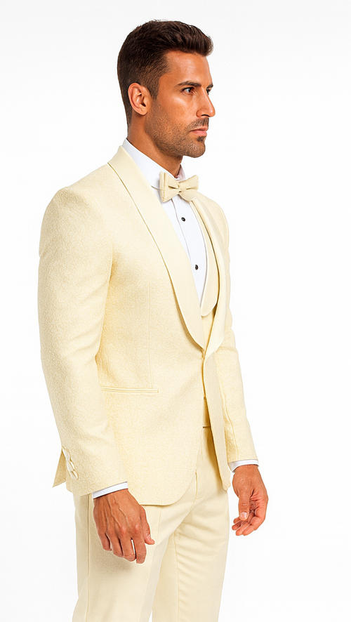Ivory designer men's tuxedo with fitted blazer, subtle floral lace, shawl collar. Includes matching trousers and bow tie. Stylish formal wear.