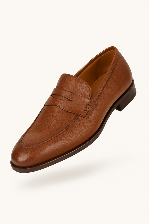 Mezlan Fabrizi penny loafer in cognac calfskin. Rounded design with penny slot. Dark brown stacked heel. Cognac leather lined. Clean, elegant simplicity.