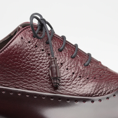 Burgundy Mezlan Postdam shoes. Deerskin/calfskin blend with a smooth, textured upper. Features perforations and contrasting dark laces. Elegant and stylish design.