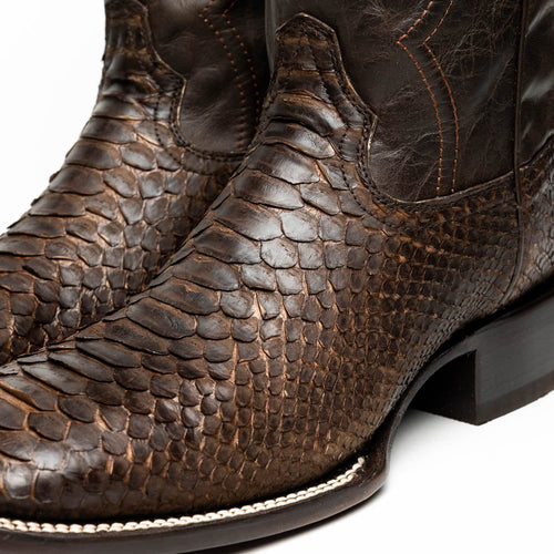 Marco Di Milano Missouri cowboy boots. Brown textured python skin upper, square toe, black leather heel. Brown stitched seams for detail. Smooth transition from skin to heel.