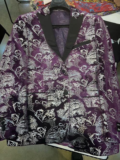 Men's tuxedo jacket with purple/white paisley floral brocade. Black satin lapel, two pockets, and a glossy finish. Intricate designs throughout.