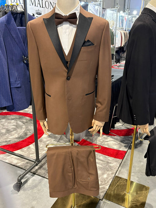 Men's light brown tuxedo suit: jacket, vest & pants. Black satin lapel, tailored fit, structured silhouette. Smooth fabric, includes pocket square.