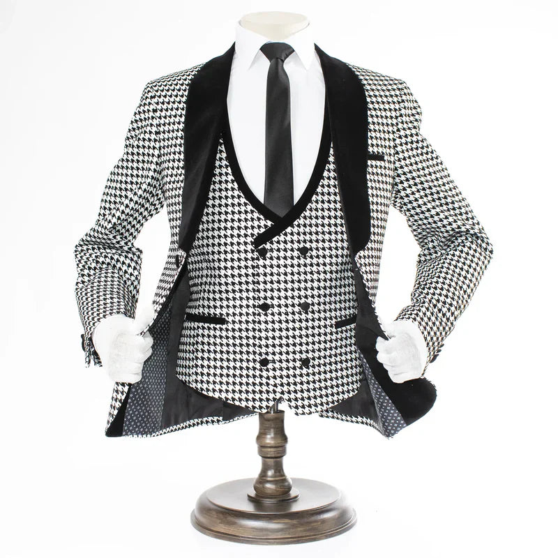 Men's houndstooth tuxedo set: black & white. Structured blazer with velvet lapel, double-breasted vest, and black trousers. Classic pattern.