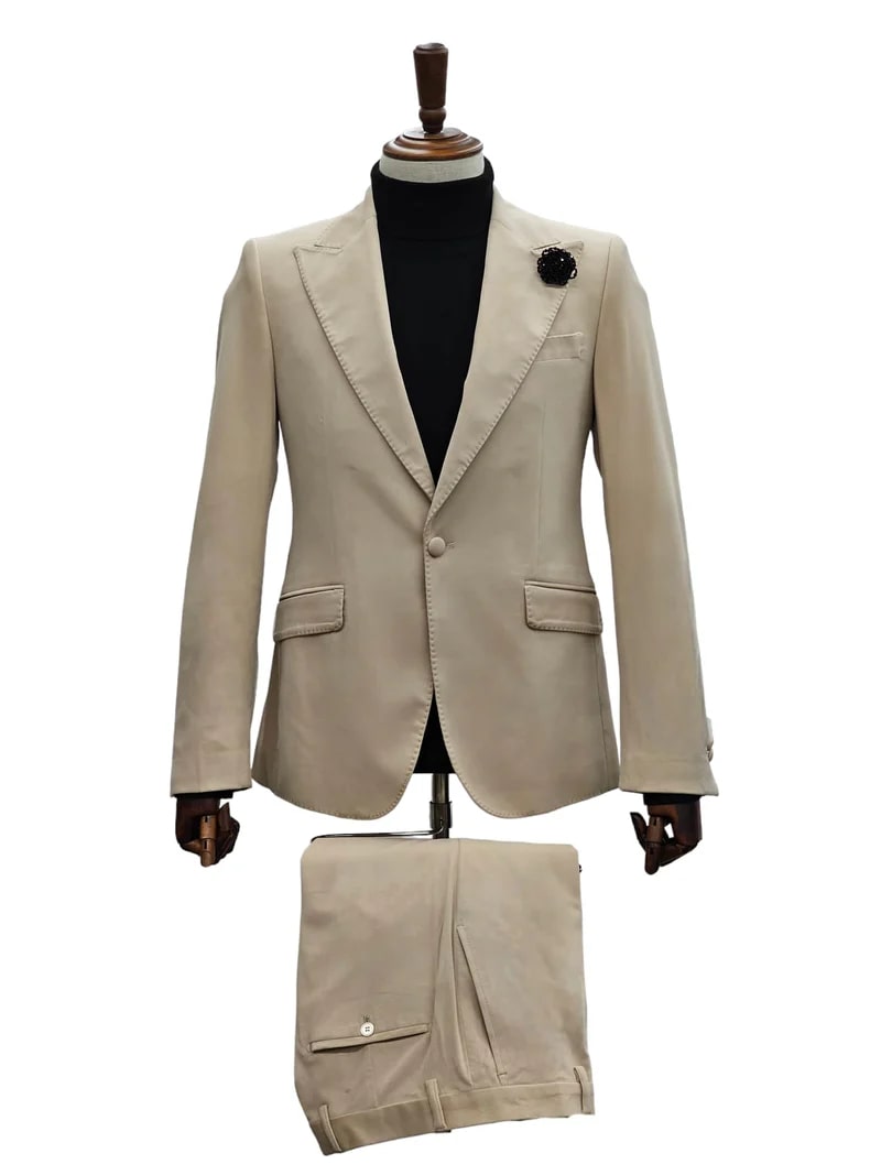 Men's sand beige velvet tuxedo suit: slim fit blazer with notched lapels, single button, front pockets. Matching trousers. Soft, textured velvet in natural beige.
