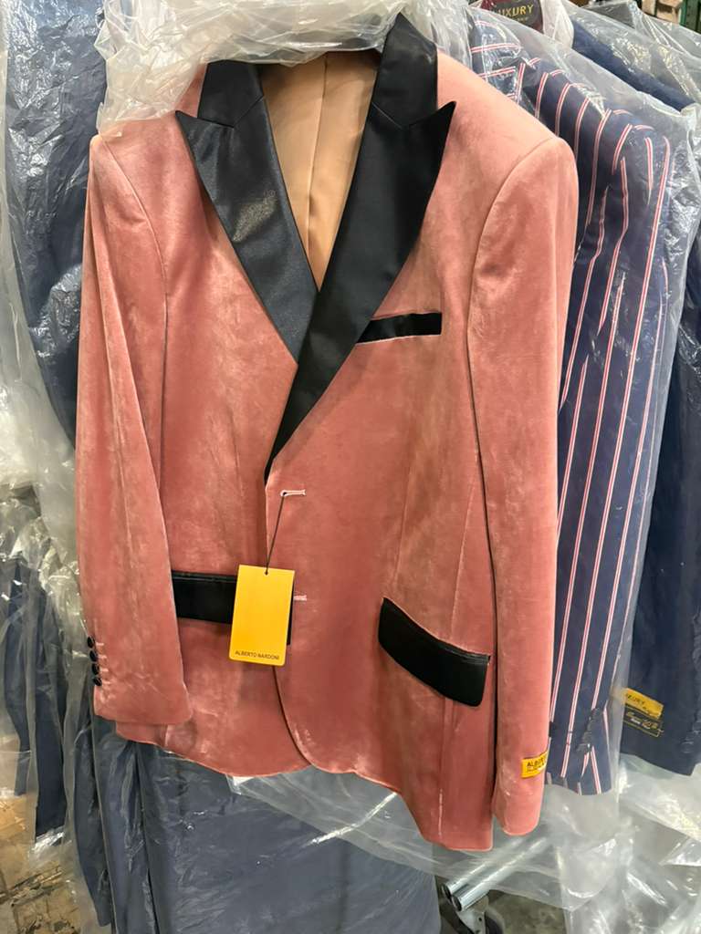 Men's dusty rose velvet blazer with black satin lapel and detailing. Single-button closure, two front pockets. A stylish, sophisticated look.