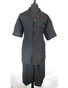 Men’s black walking suit with shorts features a short-sleeved button-up shirt and matching shorts. The shirt has a straight cut with two front pockets and a classic collar. Both items are made of a lightweight fabric, emphasizing a solid black color without any visible patterns.