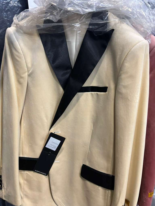 Ivory velvet men's dinner jacket with black satin lapels and pocket details. Partially covered in plastic. Classic and elegant.