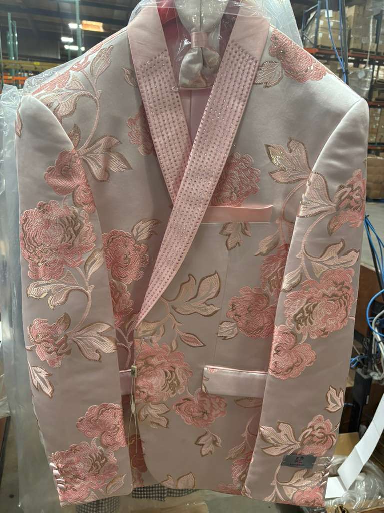 Men's pink blush floral jacquard blazer. Features an embellished shawl lapel, intricate floral patterns, and smooth fabric. Decorative pocket detailing.