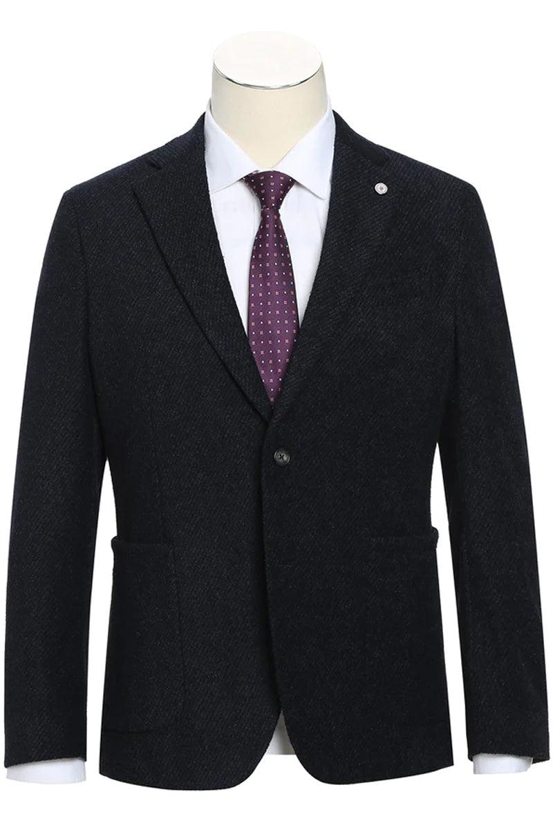 Dark cotton slim fit blazer. Textured fabric, two-button closure, notched lapel, and front pockets. Styled with a white shirt and patterned tie on a mannequin.