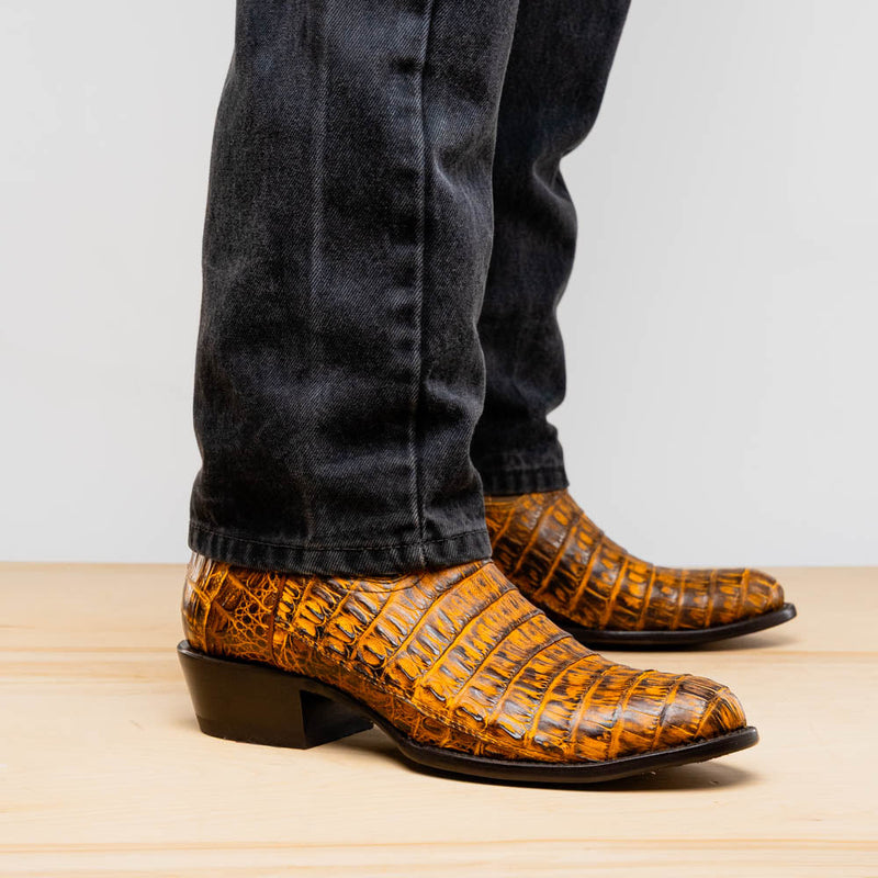 Mustard brown Marco Di Milano Phoenix cowboy boots. Round toe, crafted from caiman crocodile leather with a textured, slightly glossy finish. Low, stacked heel, snug fit.