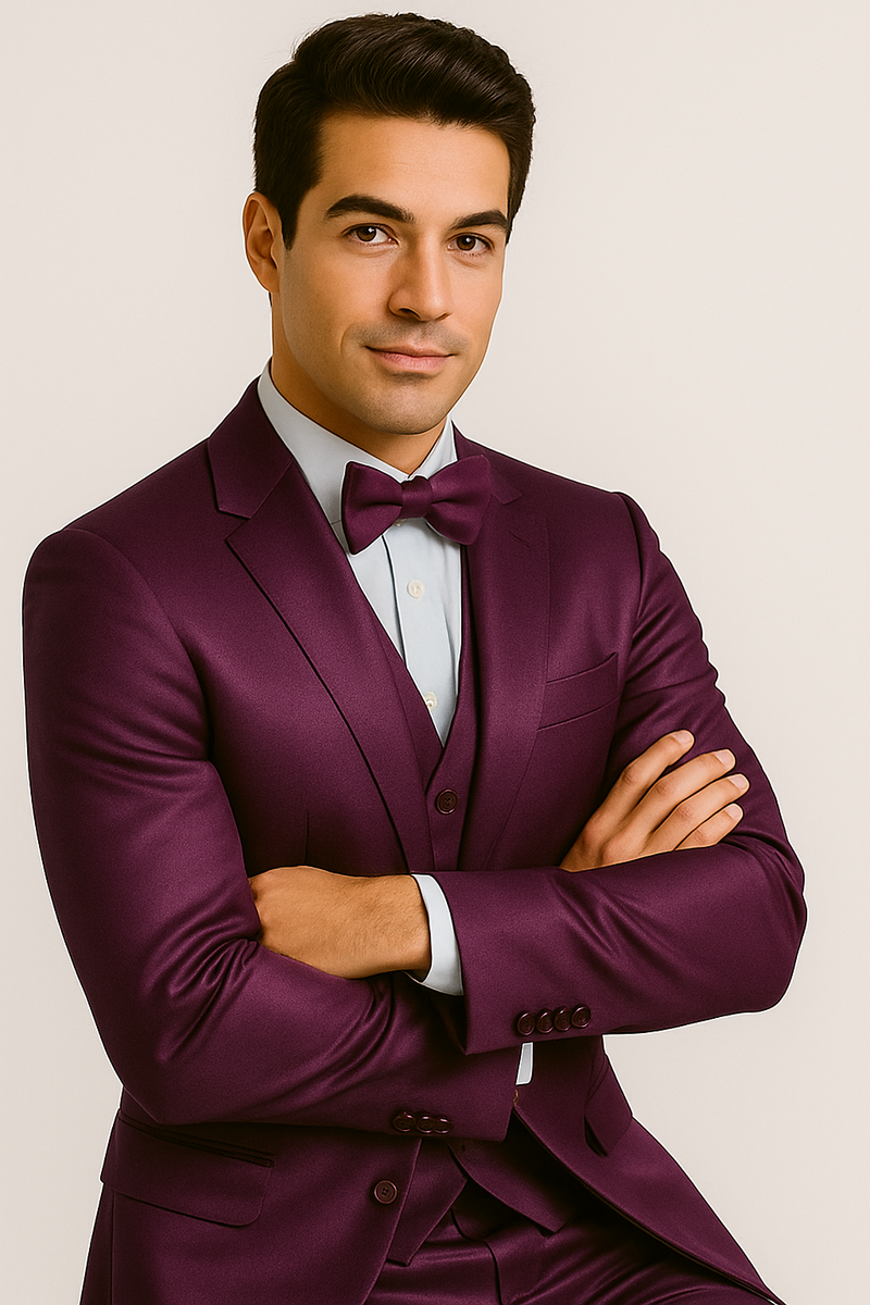 Purple majesty tuxedo: four-piece set in shiny, dark purple. Includes jacket (single-breasted, notched lapels), vest, pants, and bow tie. Paired with a light blue shirt.