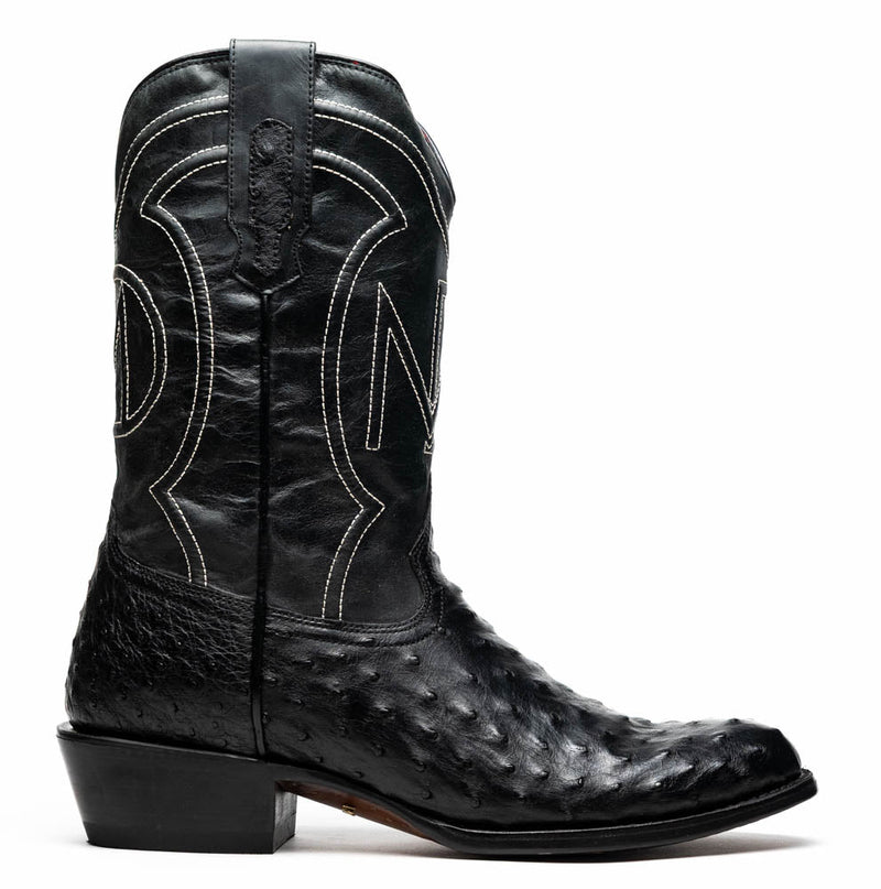 Marco Di Milano Savannah cowboy boots. Black ostrich quill leather upper with round toe & elevated heel. White stitched shaft detailing. Features pull tab.