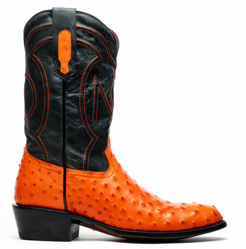 Marco Di Milano cowboy boot: orange ostrich leather with a textured base, black leather shaft. Contrasting orange stitching, rounded toe, short heel. Stylized shaft pattern, color contrast.