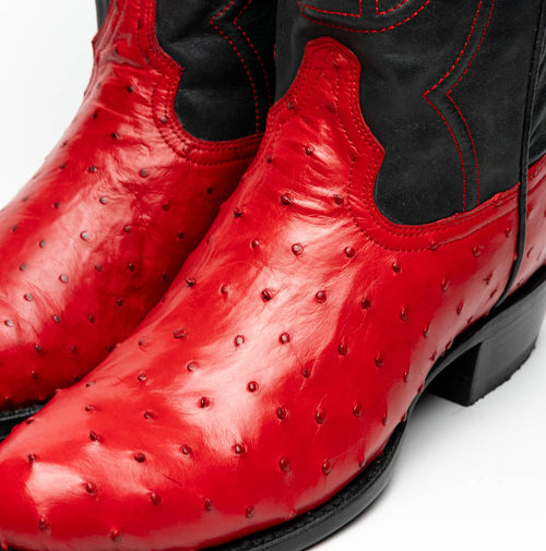 Marco Di Milano Savannah cowboy boots. Red ostrich quill leather body with textured bumps. Black upper with decorative stitching. Round toe and raised heel.