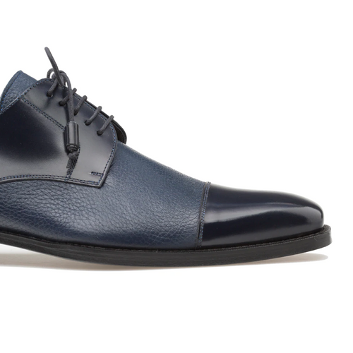 Mezlan Soka blue calfskin shoes. Textured deerskin upper with a smooth cap toe. Lace-up closure, rounded toe, and thin black sole. Features a contrast of matte and glossy finishes.