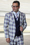 Sapphire blue plaid suit with peak lapels, Italian wool. Features a double-breasted vest. Colors: blue, beige, cream. Slim silhouette, structured shoulders. Jacket: one-button. Vest: six-button.
