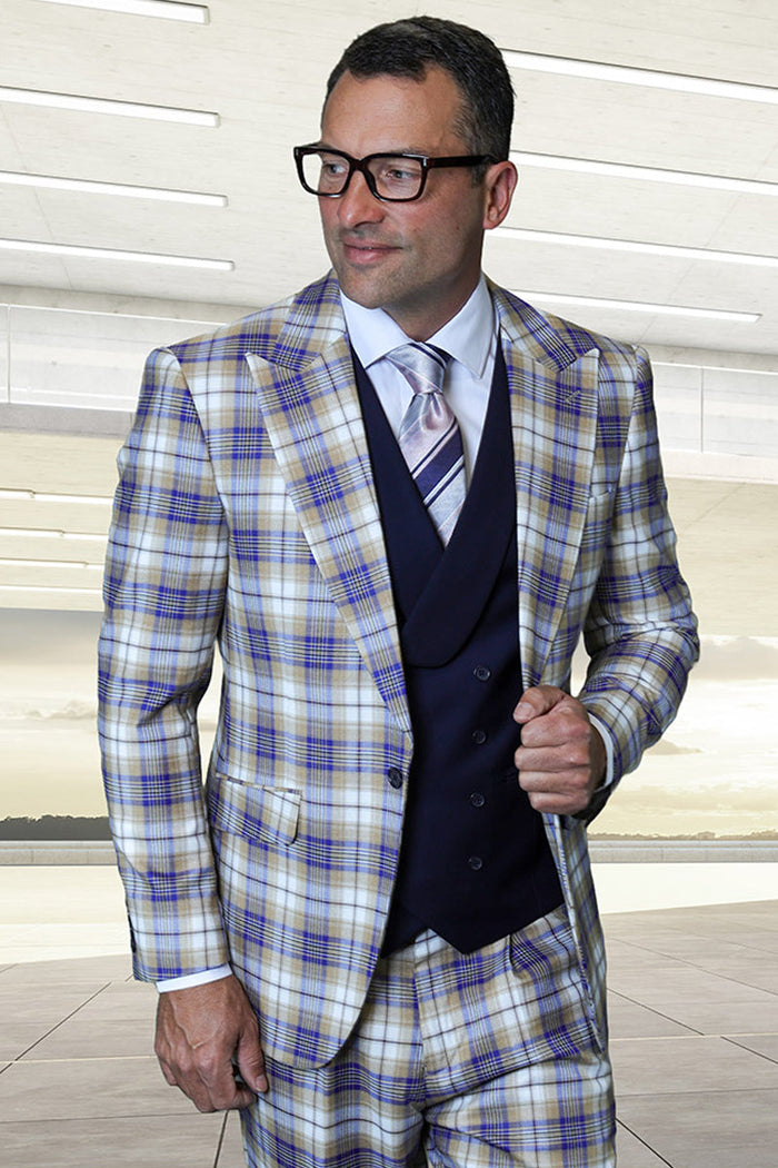 Sapphire blue plaid suit with peak lapels, Italian wool. Features a double-breasted vest. Colors: blue, beige, cream. Slim silhouette, structured shoulders. Jacket: one-button. Vest: six-button.
