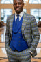 Men's designer suit: royal blue plaid Italian wool with peak lapels & single button jacket. Includes a solid royal blue double-breasted vest & tailored pants, creating a cohesive, fitted look.
