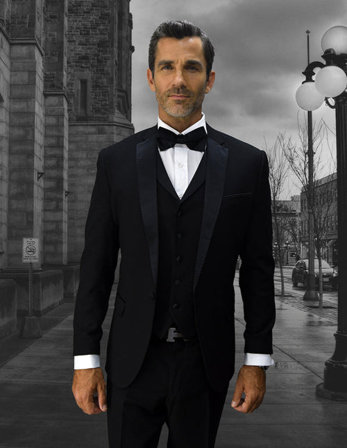 Men's black wool tuxedo with a slim-fit, one-button design. Features a notch lapel, matching vest, and satin lapels. Smooth, consistent black fabric.
