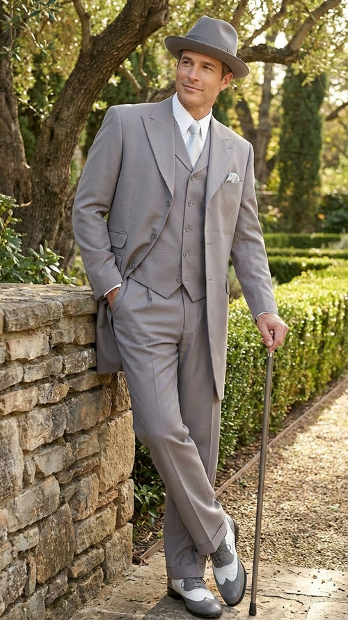 Men's gray zoot suit: double-breasted jacket, wide lapels, tapered trousers, matching hat. Includes two-tone 1920s shoes (gray/white).