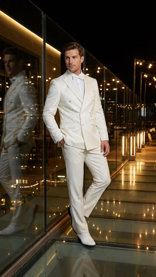 Alberto Nardoni ivory double-breasted tuxedo. Textured jacket with a fitted silhouette, shawl collar, and double buttons. Slim-cut, matching ivory trousers complete the elegant ensemble.
