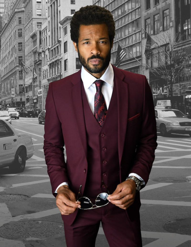 Men's burgundy skinny wool suit: 2-button jacket, matching vest, slim trousers. Fitted design, notch lapel, 5-button vest closure. Streamlined silhouette.