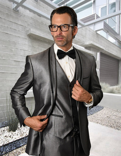 Silver sharkskin tuxedo with satin shawl lapels. Slim-fit, one-button closure. Includes matching vest. Shiny fabric for a formal look.
