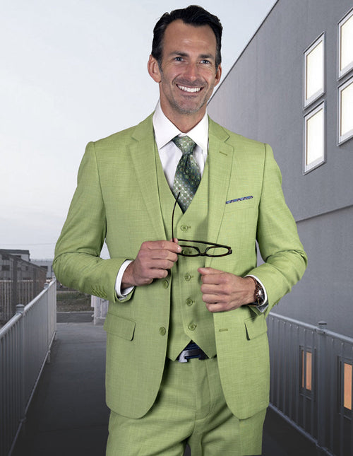 Men's slim fit, 2-button wool suit in light pistachio green. Includes jacket, vest, and trousers. Structured silhouette, minimalist design, and smooth wool texture.