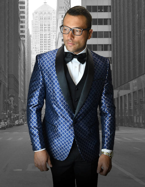 Navy one-button shawl tuxedo with geometric chain print. Glossy fabric, classic shawl lapel, and fitted silhouette. Features interlocking shapes for visual texture. Worn with white shirt & black bow tie.
