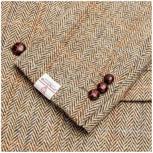 Harris Tweed Blakemore Blazer: Herringbone pattern (beige, brown, light blue). Tweed fabric. Branded tag. Dark brown cuff buttons.
