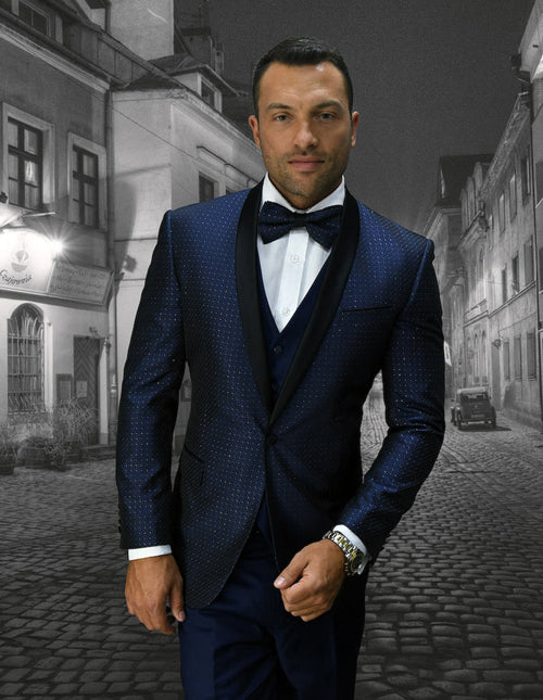 Navy blue men's tuxedo with mini diamond print. Tailored fit, shawl collar, and matching vest. Offers a classic and sophisticated look.
