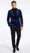 Men’s black and royal blue patterned blazer featuring a floral design with a glossy texture. The blazer has a single button front closure and peaked lapels.