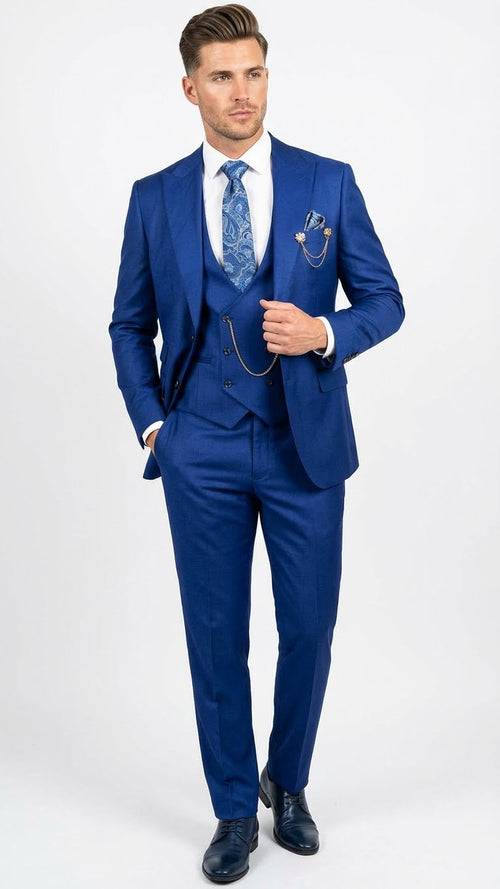 Royal blue three-piece men's suit: fitted jacket, trousers, and vest with subtle button closure. Smooth, slightly sheened fabric. Includes a blue patterned tie.
