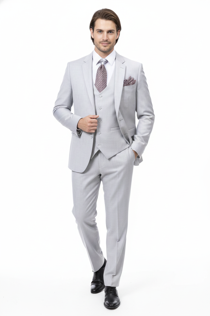 Men's light gray three-piece wedding suit. Two-button jacket, matching vest, tailored trousers. Smooth fabric with subtle texture. Perfect for a sophisticated wedding.
