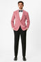 Pink velvet tuxedo jacket with shawl lapel. Slim fit, soft texture, and a vibrant pink hue. Styled with black bow tie, white shirt, and black trousers for a formal look.
