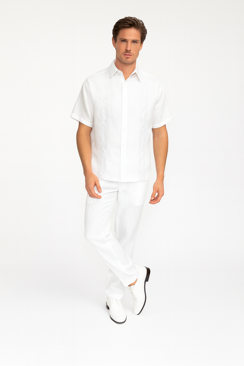 White linen guayabera set for men: short-sleeve shirt and straight-leg pants. Lightweight linen construction. Shirt features detailed front embroidery. Solid white color.

