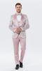 Men's light pink dusty rose floral tuxedo suit: Fitted jacket with floral design, satin lapels. Matching trousers and coordinated bow tie complete the ensemble.
