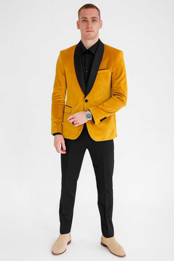 Men's tuxedo jacket in mustard gold velvet with black satin shawl collar. Fitted silhouette, black trim pocket, and classic black lapels.
